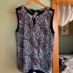 Adorable, sleeveless blouse, ties in back behind neck.